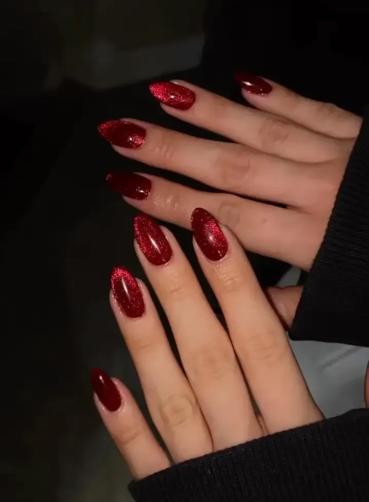 Dark red cat eye nails.