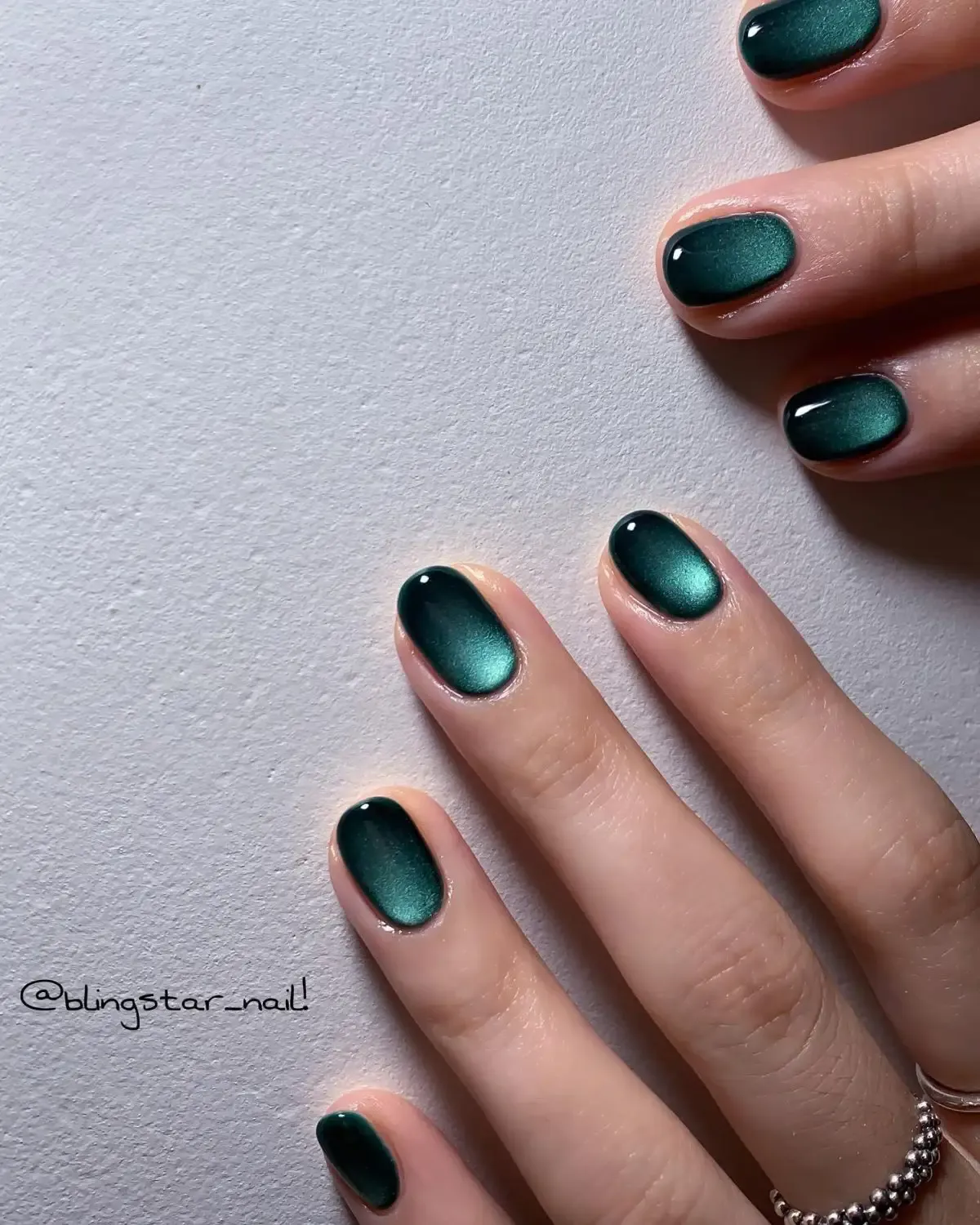 Short emerald green velvet nails.